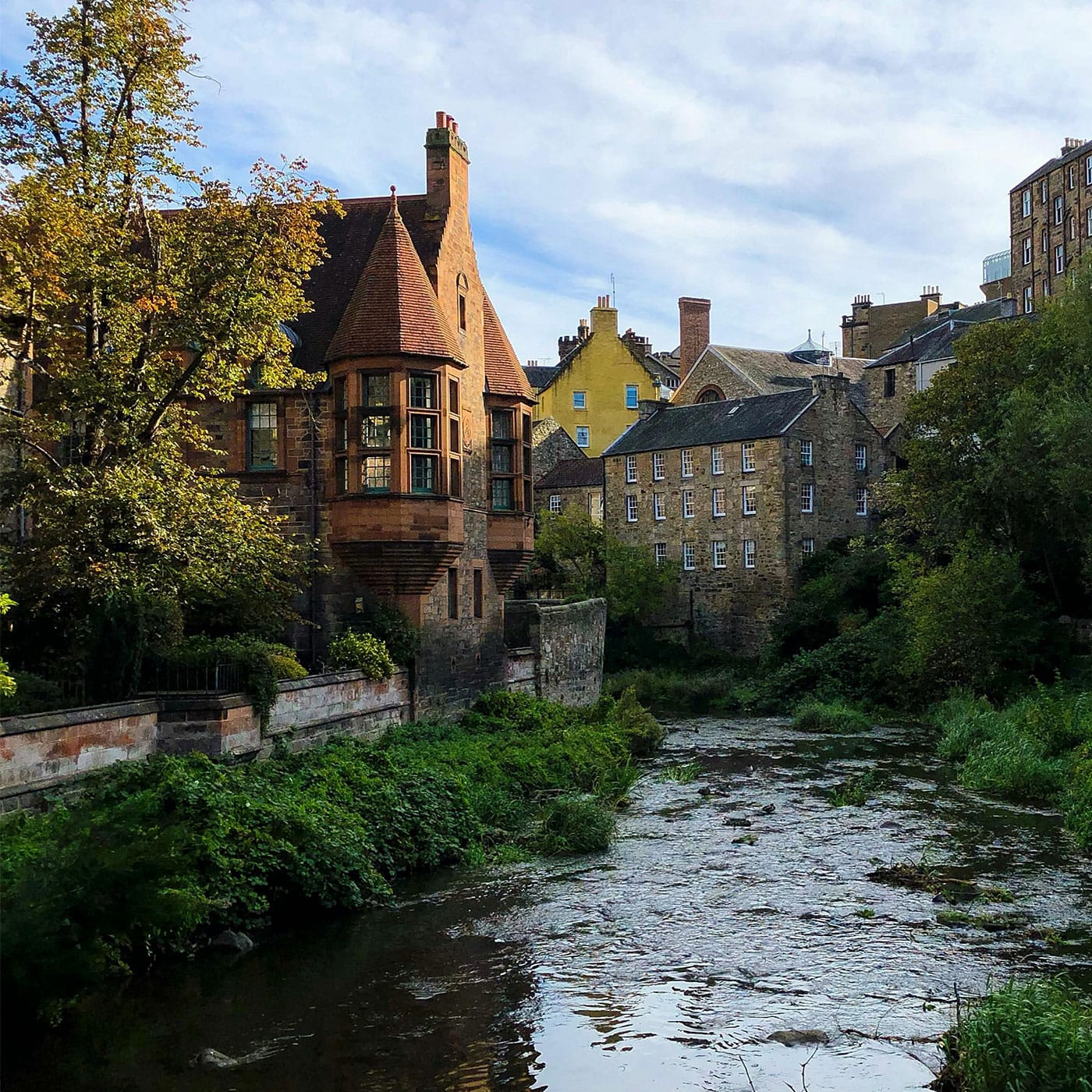 A river in Scotland runs between buildings in the city. 